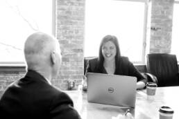 Frau in Meeting vor Laptop
